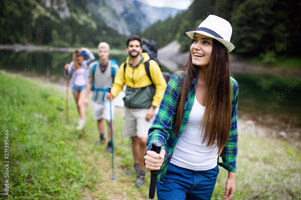 Hiking with friends is so fun. Group of young people with backpacks hiking together Hiking with friends is so fun. Group of young people with backpacks hiking together