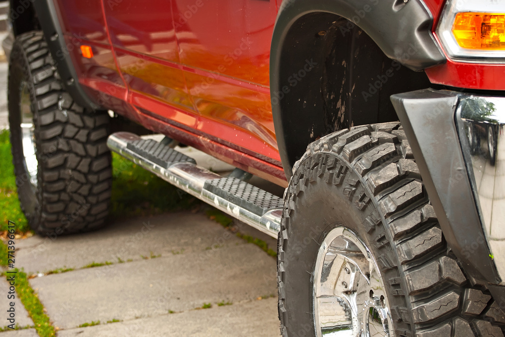 Wheels, lights and bumper are laced in a swamp. Dirty truck parts close up. Wheels, lights and bumper are laced in a swamp. Dirty truck parts close up.