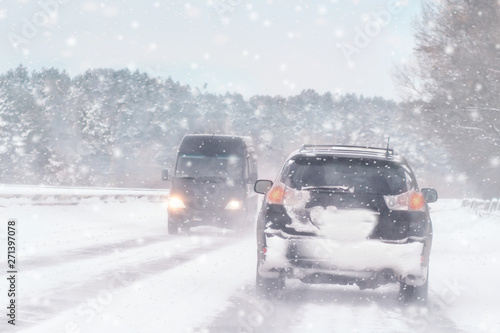 Slika na platnu Driving in snow storm on bad winter Road