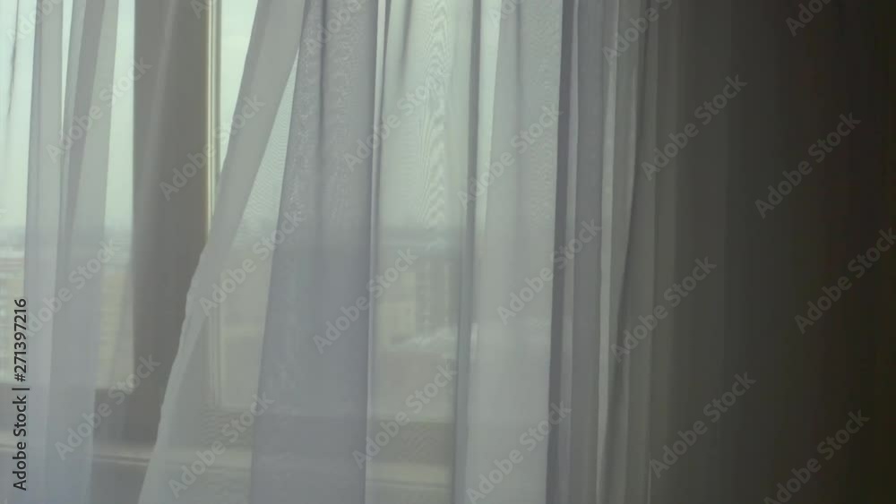 Moving grey transparent curtains at wide window. Filmed with drone Moving grey transparent curtains at wide window. Filmed with drone