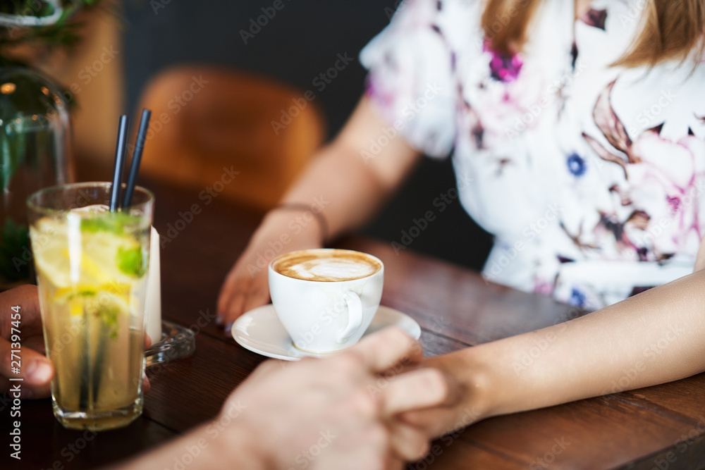 Midsection of romantic couple dating in restaurant Midsection of romantic couple dating in restaurant
