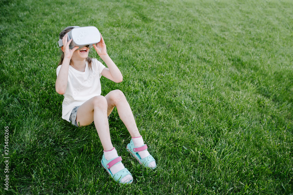 Kid girl using virtual reality glasses outside Kid girl using virtual reality glasses outside