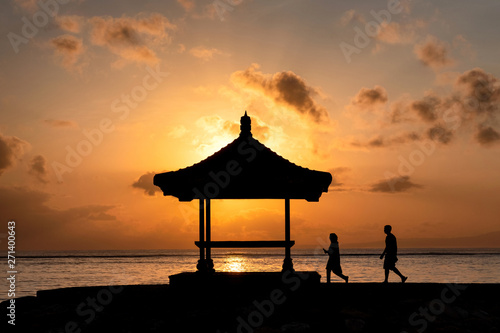 Silhouette couple walking to pavilion with sunrise shining © Mumemories