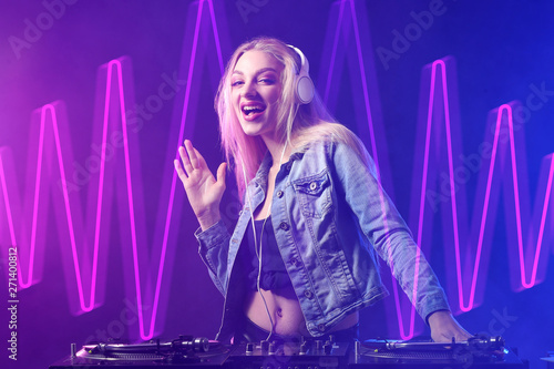 Female DJ playing music in ...