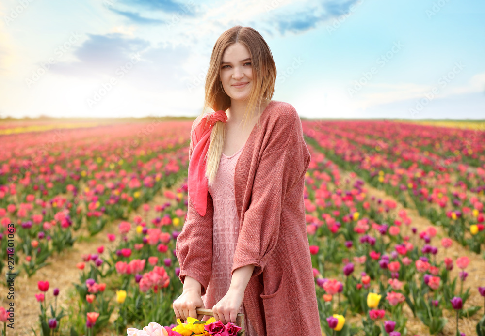 Beautiful young woman in tulip field on spring day Beautiful young woman in tulip field on spring day