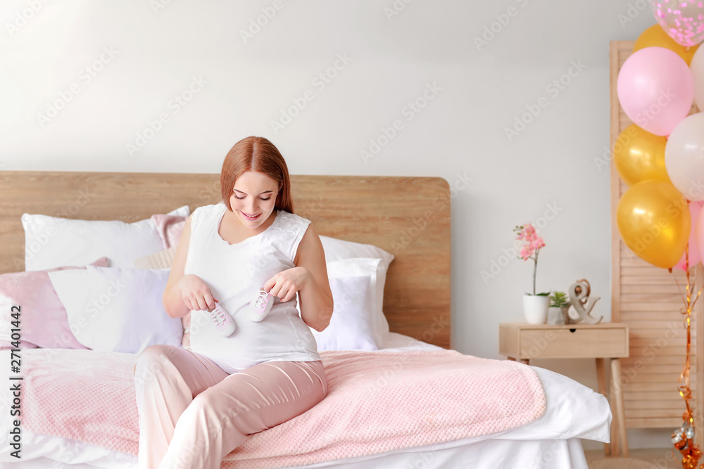 Beautiful pregnant woman sitting on bed Beautiful pregnant woman sitting on bed