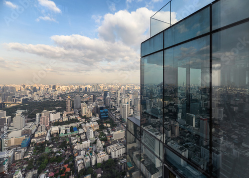 Modern glass building with crowded downtown at bangkok city