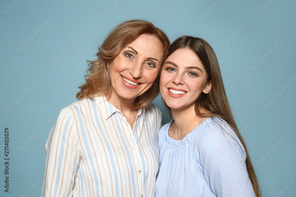 Portrait of happy mother with her daughter on color background Portrait of happy mother with her daughter on color background