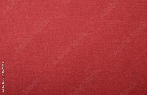 Texture of bright red fabric with visible threads