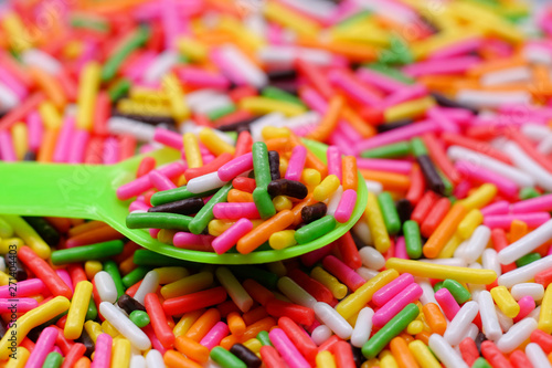 colorful sugar sprinkles on plastic spoon