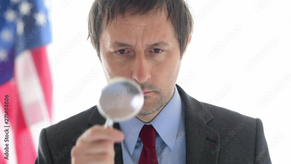 American tax inspector with magnifying glass doing business financial auditing