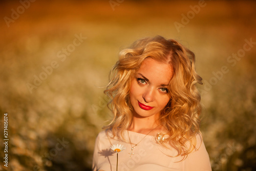 beautiful girl with white hair enjoys a field of daisies
