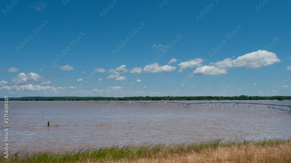 Irrigation farm equipment in flooded field