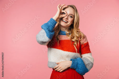 Happy excited young pretty beautiful woman posing isolated over pink wall background.
