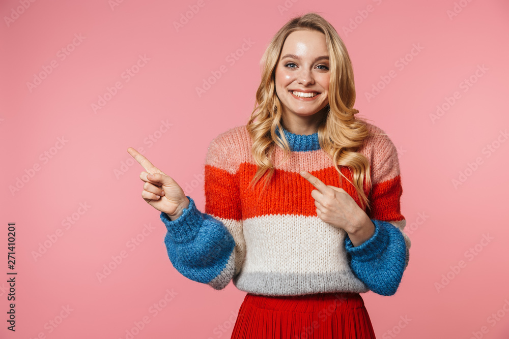 Young pretty beautiful woman posing isolated over pink wall background pointing to copyspace. Young pretty beautiful woman posing isolated over pink wall background pointing to copyspace.