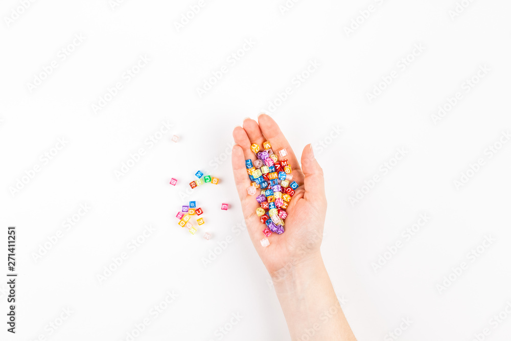 Woman hand with multicolor alphabet Woman hand with multicolor alphabet