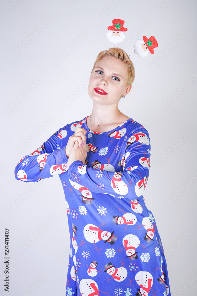 pretty blonde girl with short hair wearing christmas funny bright dress on white studio background alone pretty blonde girl with short hair wearing christmas funny bright dress on white studio background alone