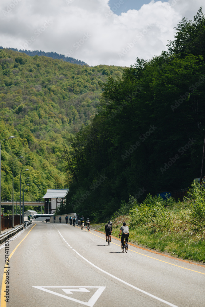 cyclists on the mountain road cyclists on the mountain road