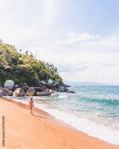 Girl walking on tropical beach in Brazil photo