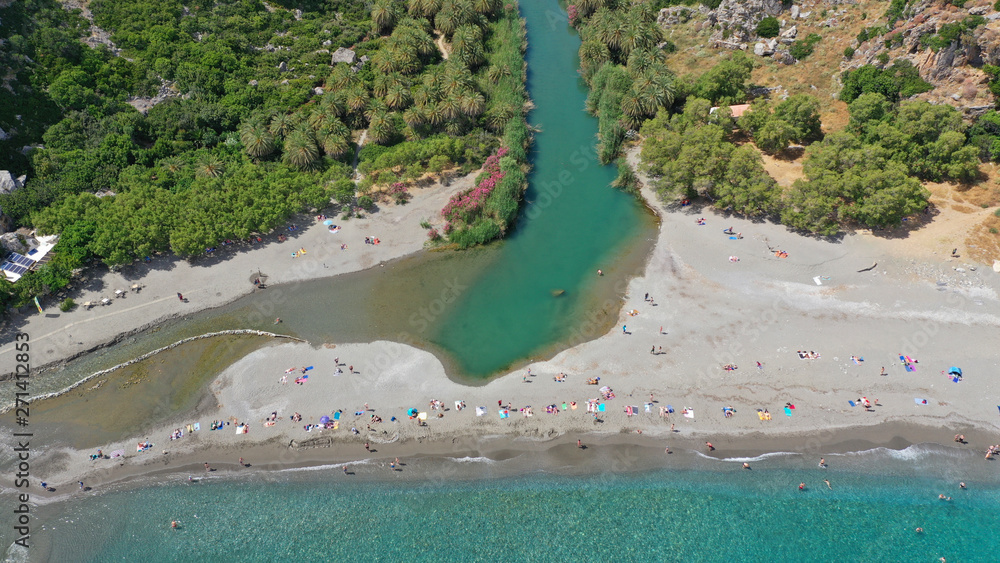 Aerial drone panoramic view of Preveli paradise palm beach and lagoon with Palm trees in the South from city of Rethymno, Crete, Greece