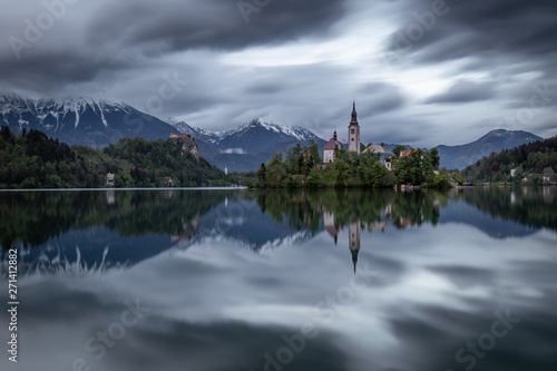 Dramatic sky over Lake Bled with majestic church on island © yorgil