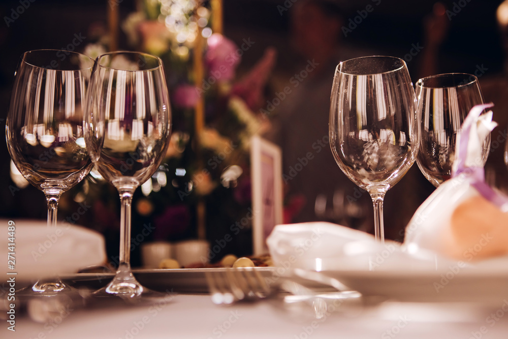 Round white table with elegant compositions from natural flowers. Banquet at the luxury wedding. Elegant design wedding table. Round white table with elegant compositions from natural flowers. Banquet at the luxury wedding. Elegant design wedding table.