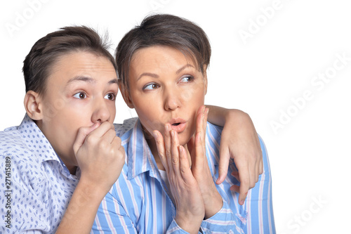 Surprised mother and son on white background