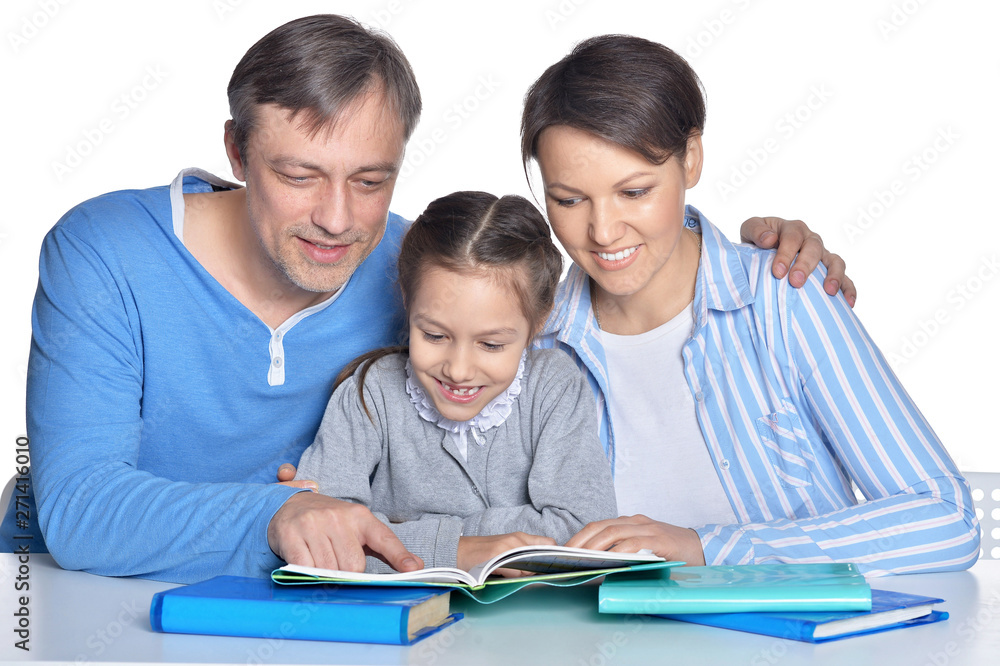Happy parents and daughter doing homework on white background Happy parents and daughter doing homework on white background