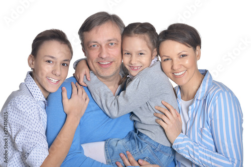 Happy smiling family posing together on white background