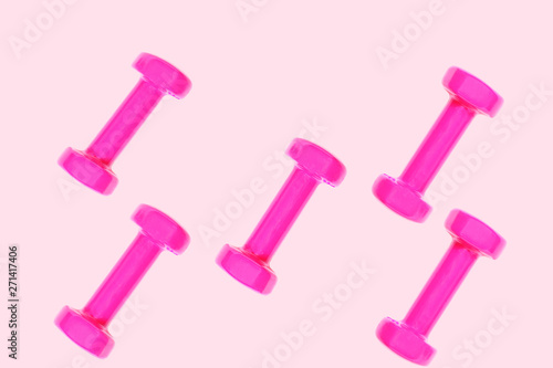 Pink purple dumbbell pattern on pastel pink background with copy space, isolated. Creative layout for sport fitness equipment concept. Minimal style, flat lay, top view. Copy space