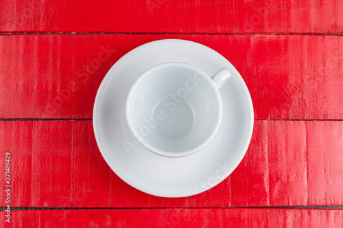 White coffee cup isolated on a red background.