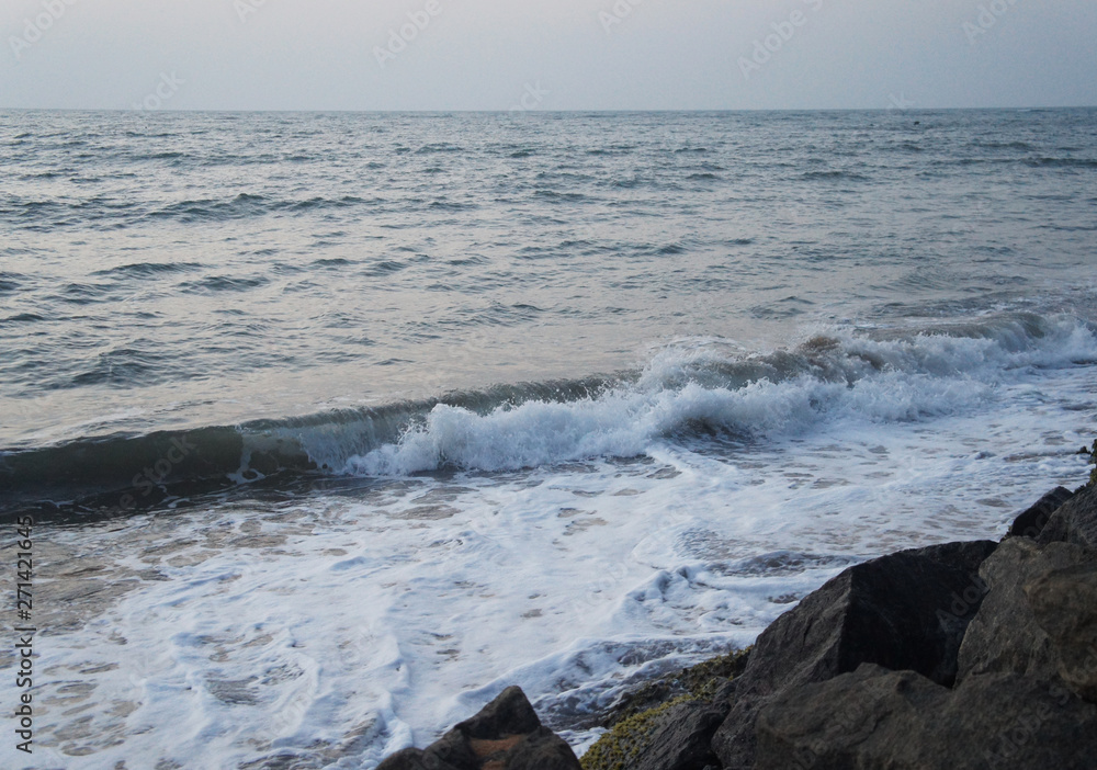 Fototapeta premium Southern tropical summer evening ocean coast at sunset. Restless sea and waves.