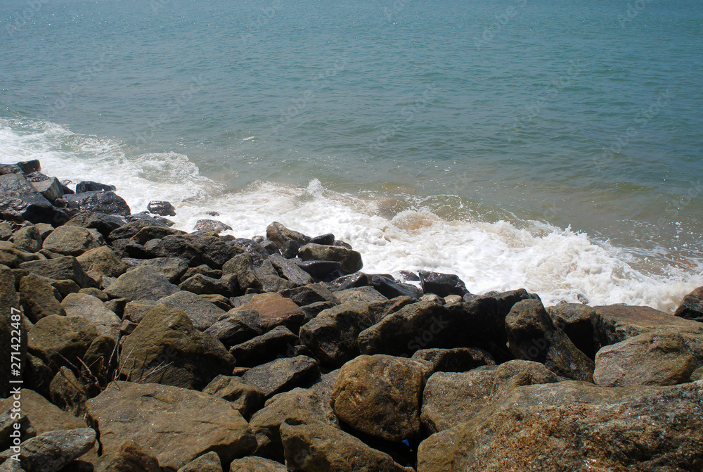 Southern tropical summer ocean coast with rocks and rocks. Lagoon with a yellow sandy beach and azure water. Southern tropical summer ocean coast with rocks and rocks. Lagoon with a yellow sandy beach and azure water.