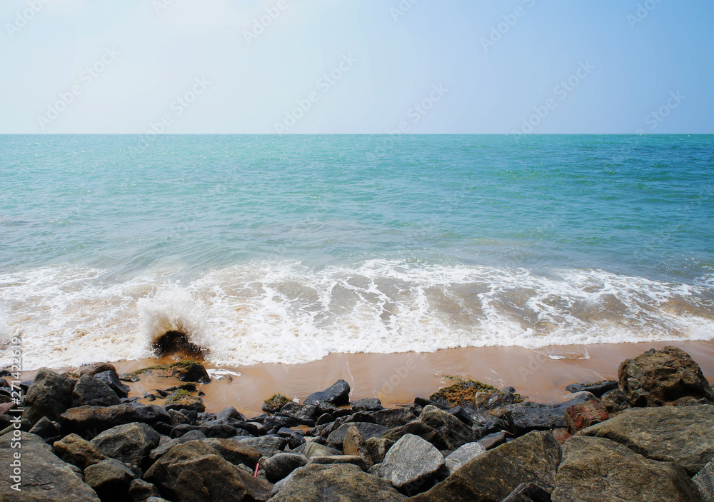 Southern tropical summer ocean coast with rocks and rocks. Lagoon with a yellow sandy beach and azure water. Southern tropical summer ocean coast with rocks and rocks. Lagoon with a yellow sandy beach and azure water.