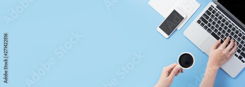 Fotografija Freelancer blog writer woman drinking for relax on a clean light blue desk with