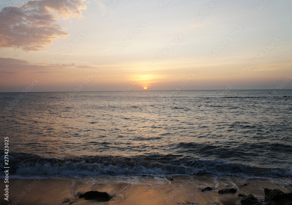 Southern tropical summer ocean coast at sunset. Lagoon with waves in which the sun is reflected. Southern tropical summer ocean coast at sunset. Lagoon with waves in which the sun is reflected.