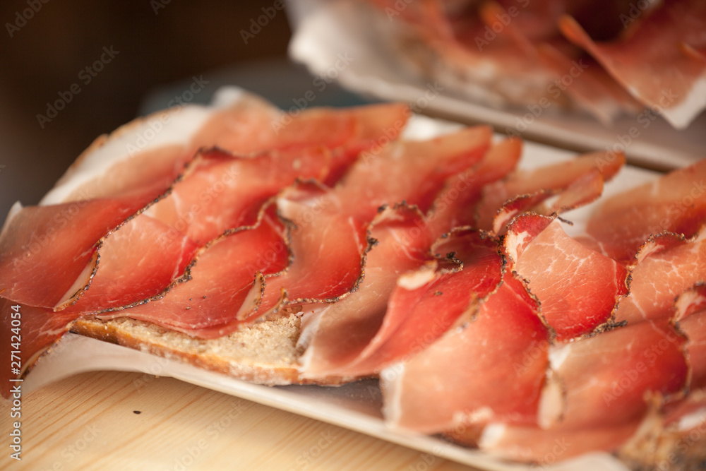 Traditional smoked speck sliced on site during the Traditional smoked speck sliced on site during the