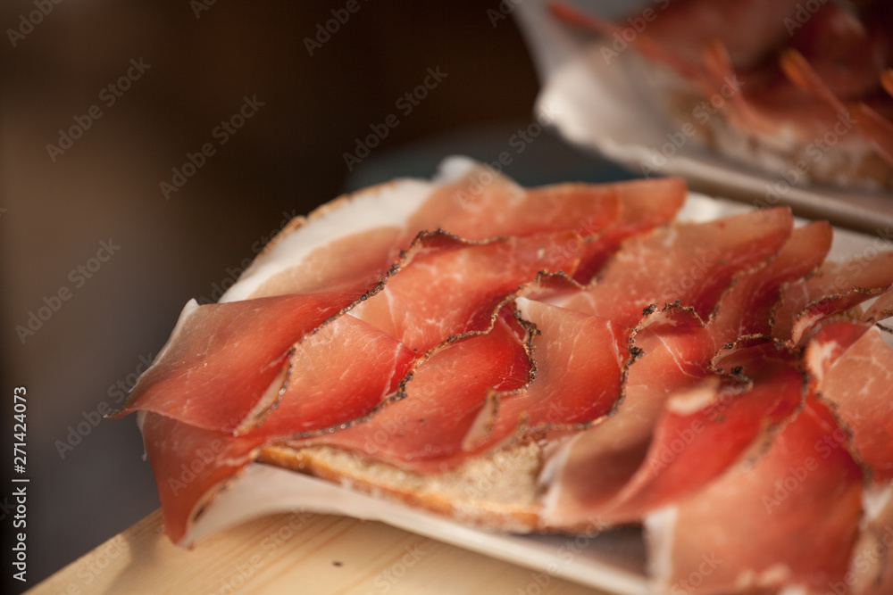 Traditional smoked speck sliced on site during the 