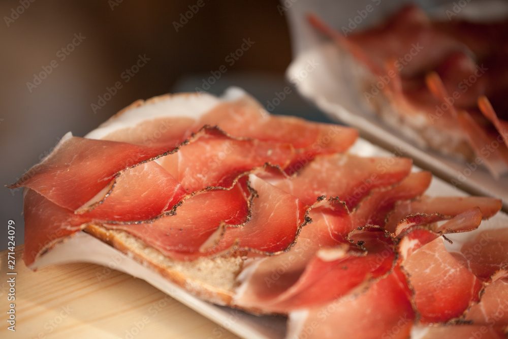 Traditional smoked speck sliced on site during the Traditional smoked speck sliced on site during the