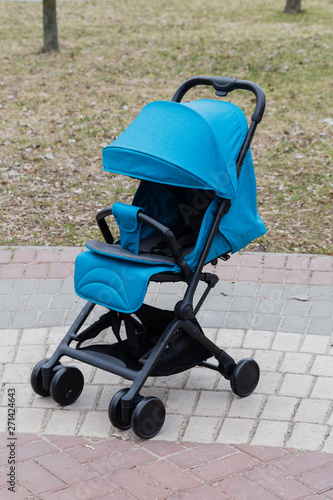 Beautiful baby carriage in the park. New design.