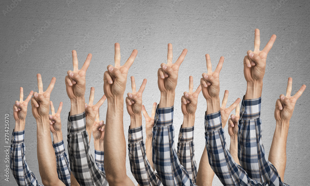 Row of man hands showing victory gesture