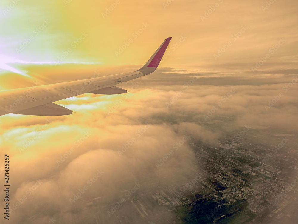 View from airplane window to see sky on Morning sunrise with Wing of an airplane View from airplane window to see sky on Morning sunrise with Wing of an airplane