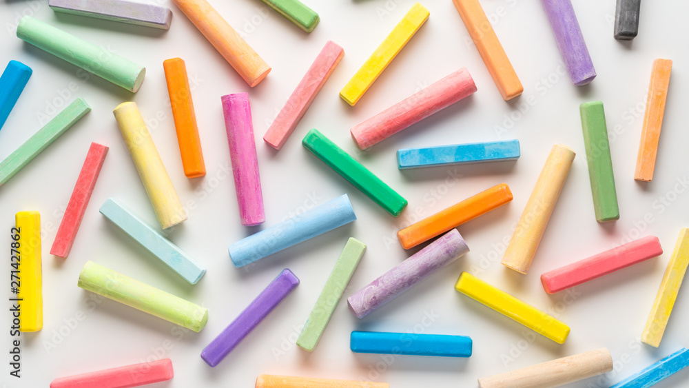 flat lay of different multicolor chalks like background on white, concept of education or business, panorama flat lay of different multicolor chalks like background on white, concept of education or business, panorama