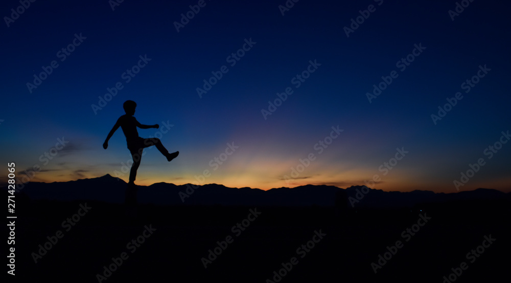 Silhouette of man doing walking at sunset, Concept lifestyle freedom vacation travel.