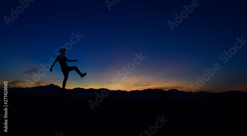 Silhouette of man doing walking at sunset, Concept lifestyle freedom vacation travel. © banphote