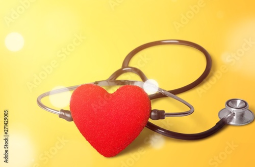 Red heart and a stethoscope on backgrouund