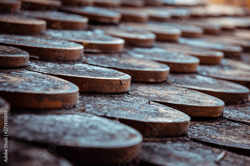 Old wooden roof. The background of old wooden pieces overlapping into a roof sheet.
