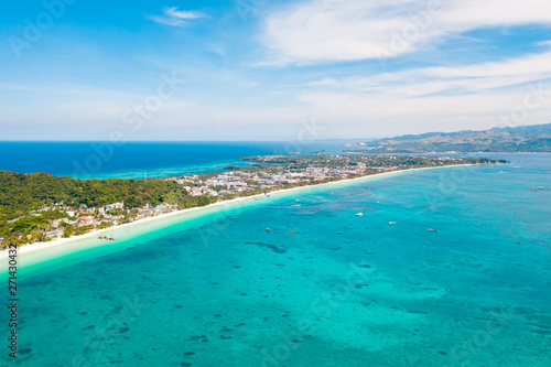 Fototapeta Naklejka Na Ścianę i Meble -  White beach on the island of Boracay, Philippines, top view. White sandy beach and turquoise sea water in sunny weather. Residential development and many hotels in Boracay.