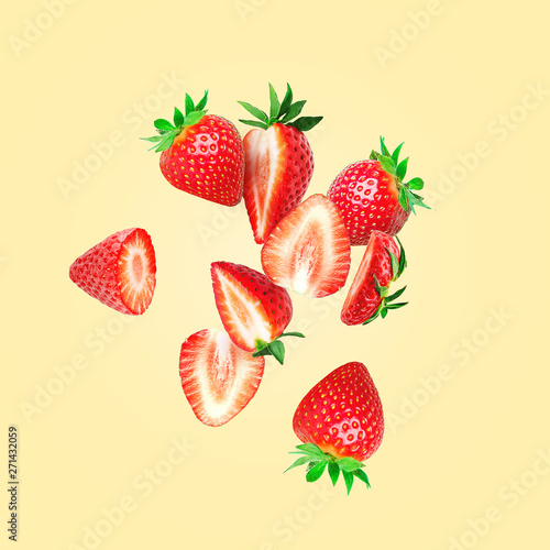 The composition of strawberries on a colored background. Cut strawberries into pieces with copy space. Fresh natural strawberry isolated