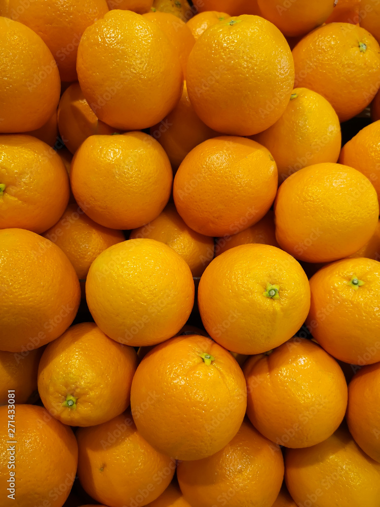 Fresh oranges that are placed on the shelves in the supermarket Fresh oranges that are placed on the shelves in the supermarket